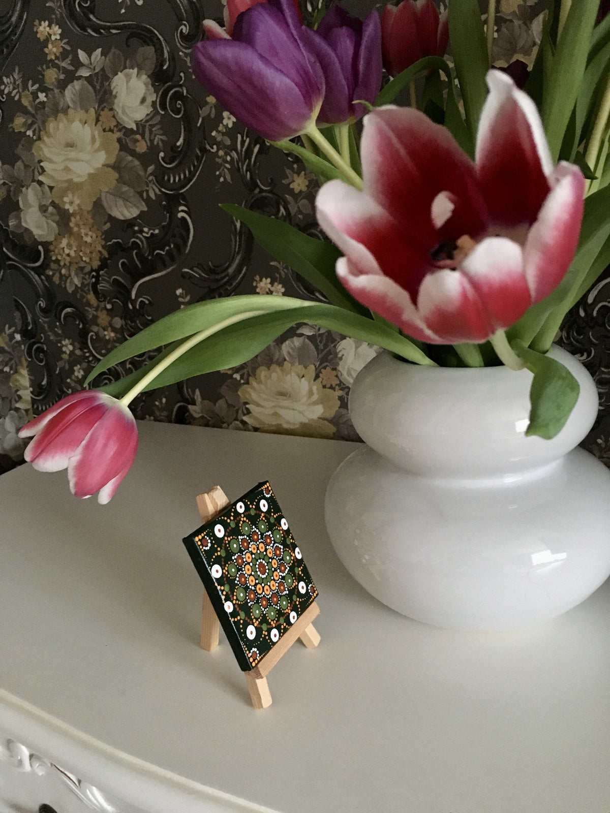 Mini green orange black bronze dot mandala by vase