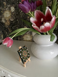 Mini green orange black bronze dot mandala by vase