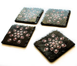 Black slate coasters decorated with red white silver dots