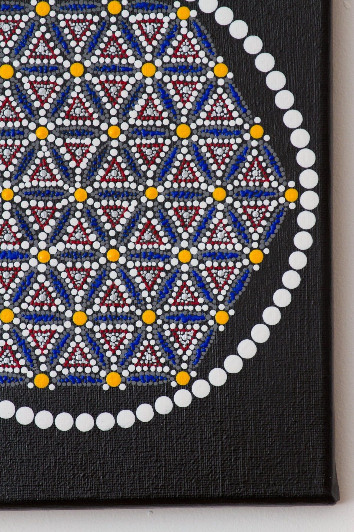 Colourful hexagon dot mandala detail, blue yellow white red