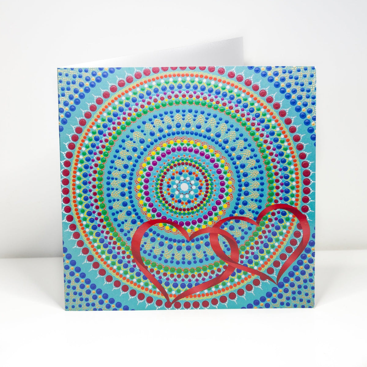 Colourful dot Mandala greeting card with red hearts