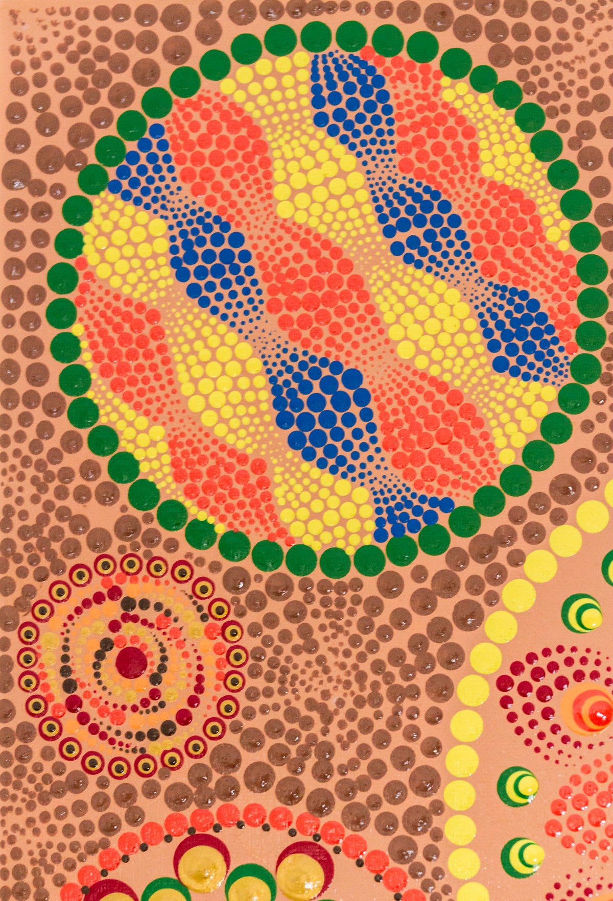 Dot Mandala detail, blue yellow red brown on peach background