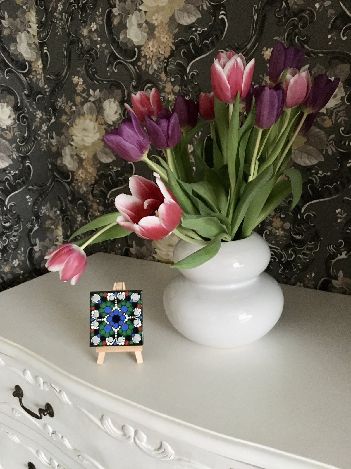 Small dot mandala with easel by vase silver green blue red white